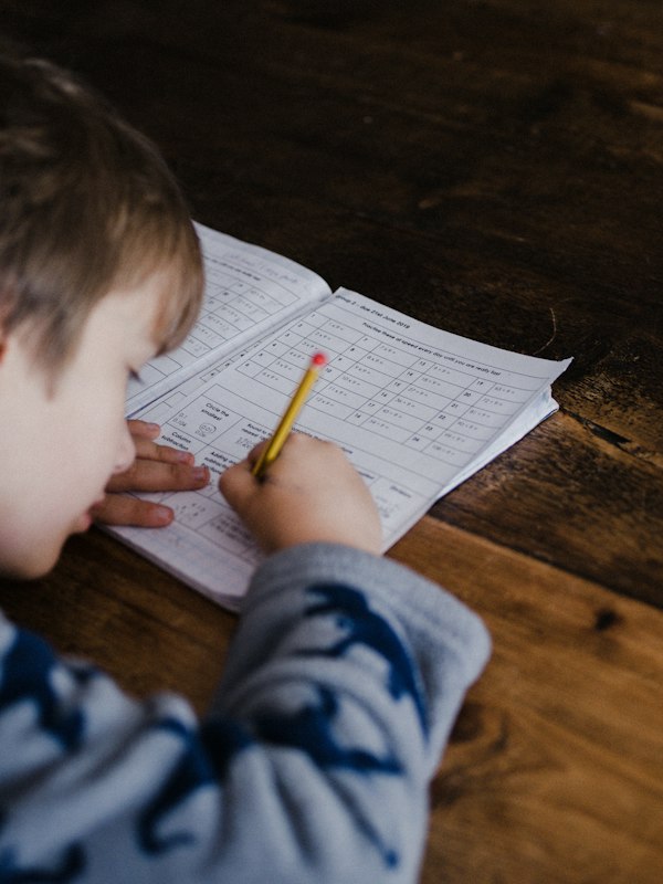 Autistic child engaged in structured, joyful independent learning with accessible tools