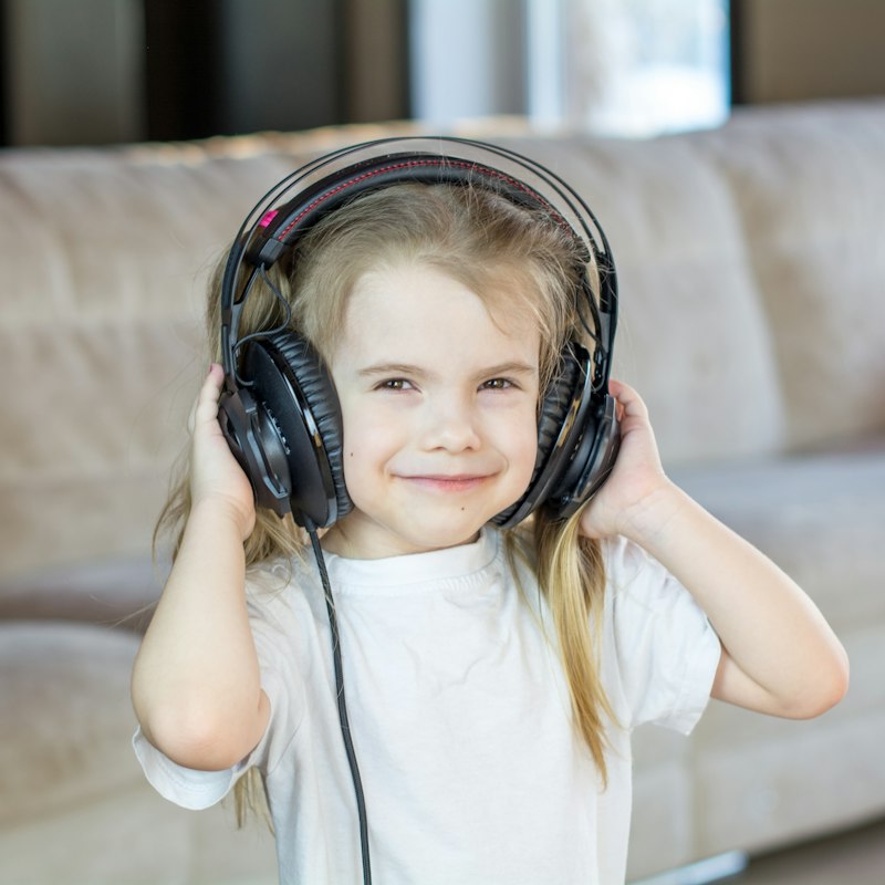 Child wearing comfortable noise-canceling headphones for sensory-safe calm regulation