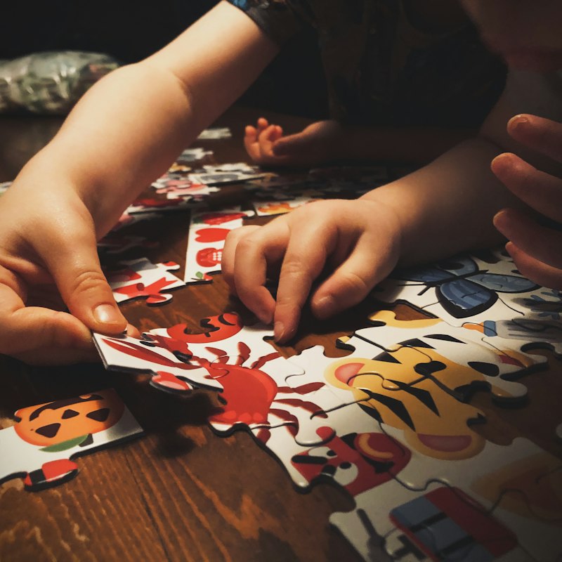 Autistic child demonstrating deep focus and problem-solving with hands-on learning puzzle